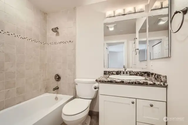 Remodeled bath with tiled tub surround and heated floors