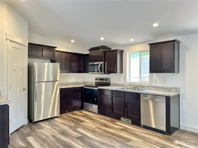 Open concept kitchen with tons of space and large pantry.