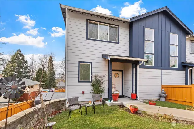 Another view of the front of the townhouse with a fenced yard.