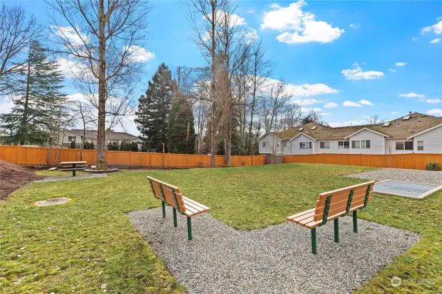 On-site community park with bench seating and picnic table.