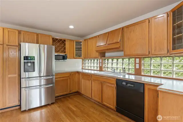 Stainless steel side by side refrigerator.  Hardwood floors in entry, kitchen and great room area.