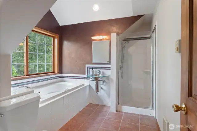 Primary bath with jetted tub and separate shower.  Tile floors