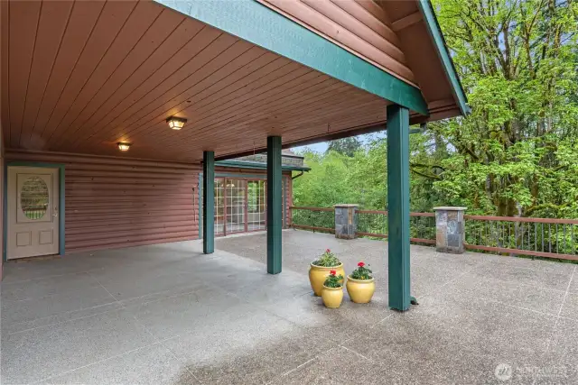 Concrete deck with covered area off living room and great room.