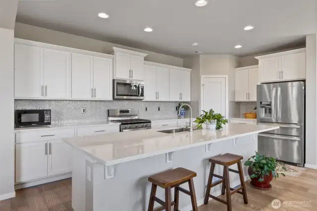 Full tile backsplash with extra outlets. Large walk-in pantry. Gas oven/range.