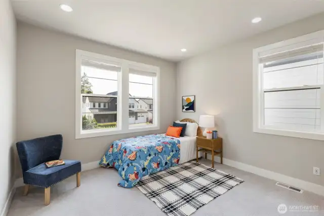 This cheerful upstairs bedroom offers a bright and versatile space with large windows, plush carpeting, and a welcoming layout. Whether used as a bedroom, guest space, or creative nook, it’s filled with natural light and cozy charm.
