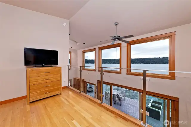 Loft with clear stainless steel and glass railing.