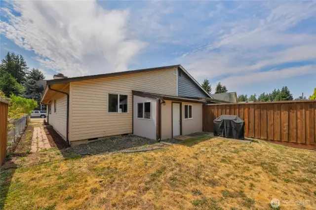 Spacious fenced backyard with enclosed patio