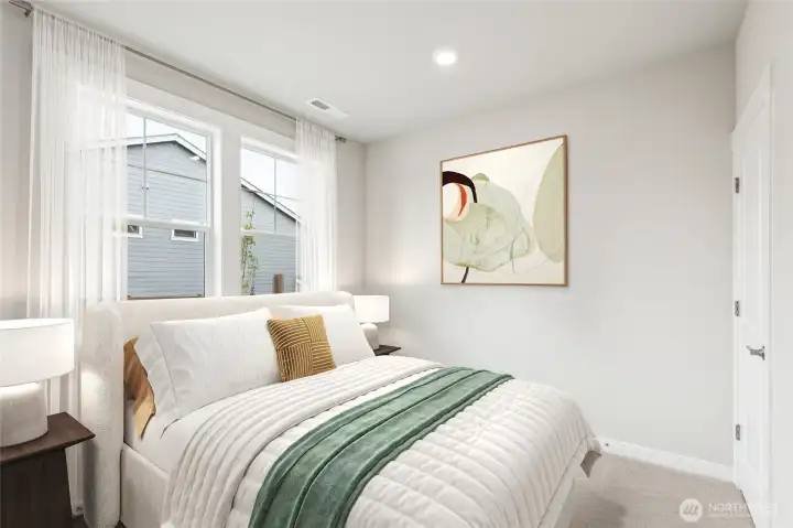Main level bedroom with bath with walk-in shower next to it. Photo is representational. Actual home is under construction and finishes and colors will vary. See site agent for details.