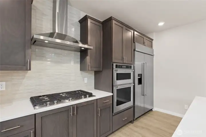 Home is equipped with gas cooktop and standalone vent. Photo is representational. Actual home is under construction and finishes and colors will vary. See site agent for details.