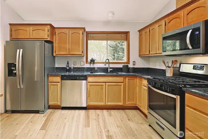 Main floor kitchen with new fridge and microwave