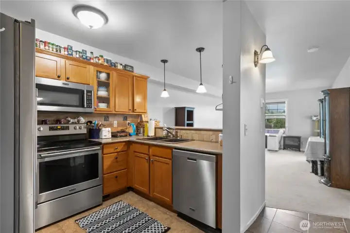 Open kitchen with maple cabinets