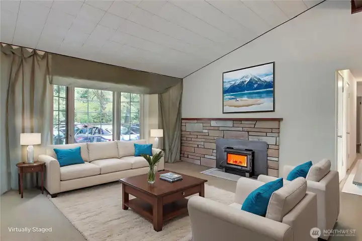The living area with vaulted ceilings is staged so you can envision what it would look like with furniture.