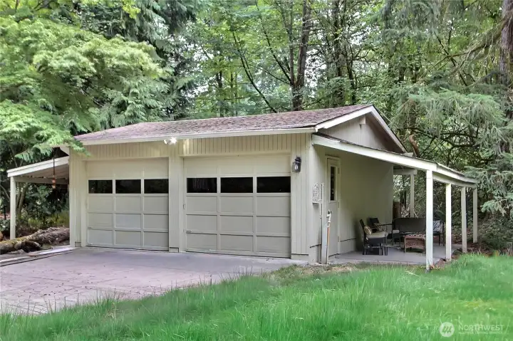 The double garage features covered areas on both sides, allowing for a ton of covered storage and/or for stacking firewood.