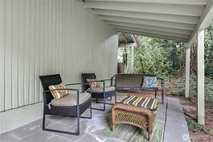 Enjoy the peaceful outdoors no matter what the weather's like on this covered patio.
