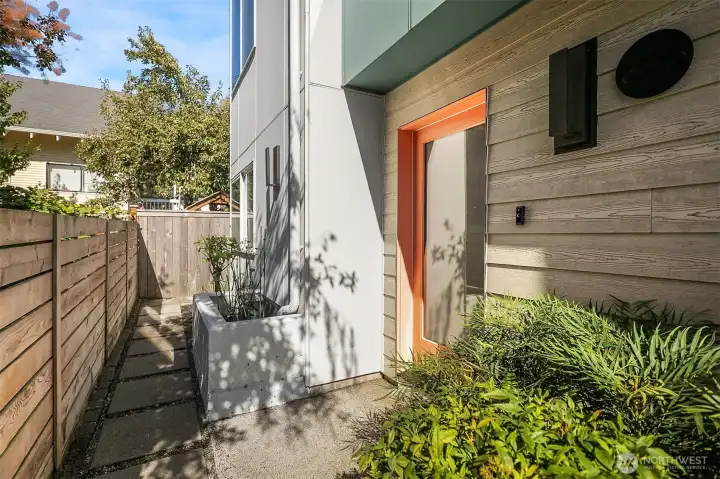 This is one of two entrances on the ground floor. This entrance is reached by a path from 13th.