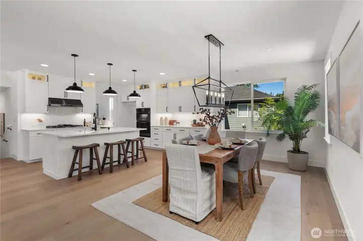 Kitchen & Dining: Bright and open kitchen with a large center island, quartz countertops, and abundant cabinetry paired with modern pendant lighting. The adjacent dining area enjoys oversized windows for natural light, creating an inviting space to gather and entertain. Staged photos are of the model home of the same floorplan within the Foxmoore community and are for visualization purposes only. Colors, finishes, and layout can and will vary.