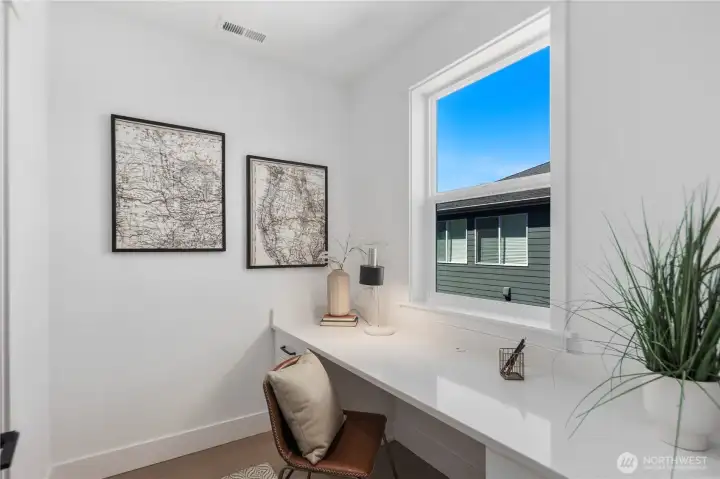 Pocket Office: Dedicated pocket office with large window and built-in desk, ideal for remote work or study. Natural light makes this a comfortable and productive space tucked just off the kitchen. Staged photos are of the model home of the same floorplan within the Foxmoore community and are for visualization purposes only. Colors, finishes, and layout can and will vary.