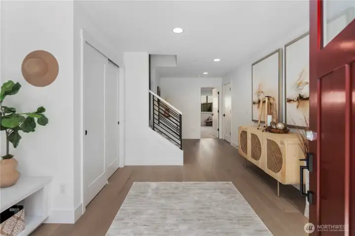 Entry Foyer: The entry foyer welcomes you with wide-plank flooring, recessed lighting, and modern iron stair railings that make an immediate statement. Ample closet space and a clean design create a functional and stylish first impression. Staged photos are of the model home of the same floorplan within the Foxmoore community and are for visualization purposes only. Colors, finishes, and layout can and will vary.