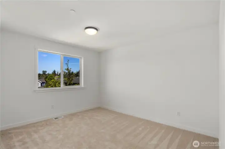 Secondary Bedroom: Spacious bedroom with plush carpet and a large window that brings in plenty of natural light. Neutral finishes provide a versatile setting ready for your personal touch. Staged photos are of the model home of the same floorplan within the Foxmoore community and are for visualization purposes only. Colors, finishes, and layout can and will vary.