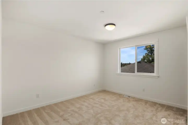 Secondary Bedroom: Bright and airy bedroom with a generous layout and soft carpeting. A perfect canvas to accommodate a variety of needs, from relaxation to productivity. Staged photos are of the model home of the same floorplan within the Foxmoore community and are for visualization purposes only. Colors, finishes, and layout can and will vary.