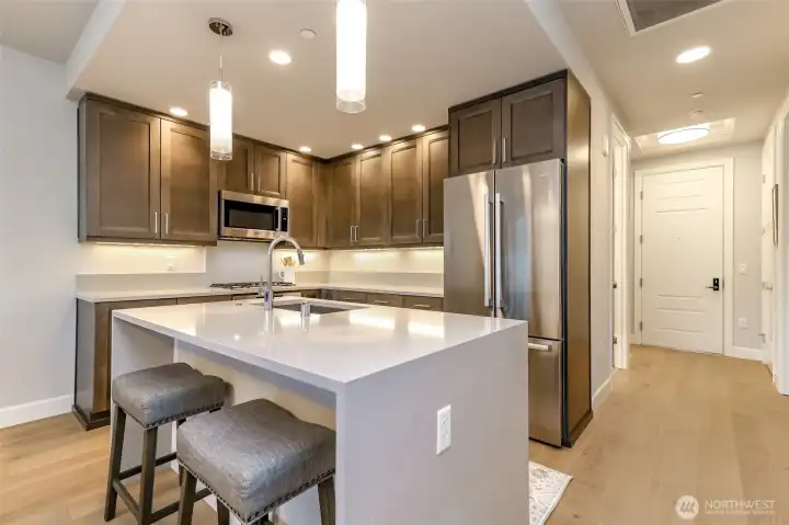 Island kitchen with high end appliances and tons of storage and pantry to the right