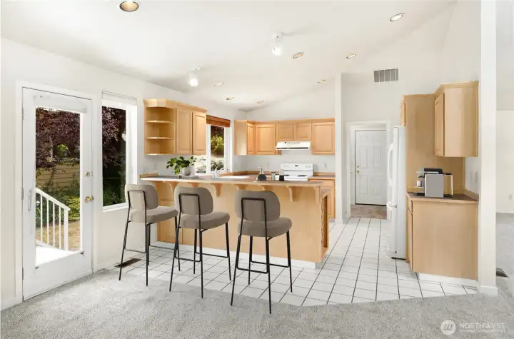Kitchen opens to hearth room and easy access to deck. virtually staged
