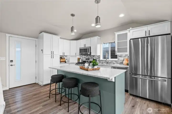 Gleaming quartz countertops on this expansive island!