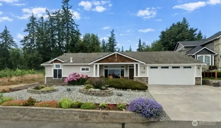 Seller-provided photo showing the landscaping in full bloom.