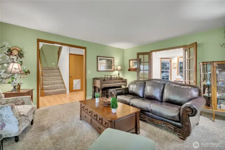 Additional view of the living area, highlighted by elegant French doors leading into the den/office.