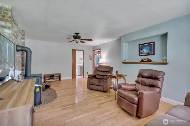 Additional view of the family area, highlighting the utility room through the pocket door and the kitchen eating space conveniently located just to the right.