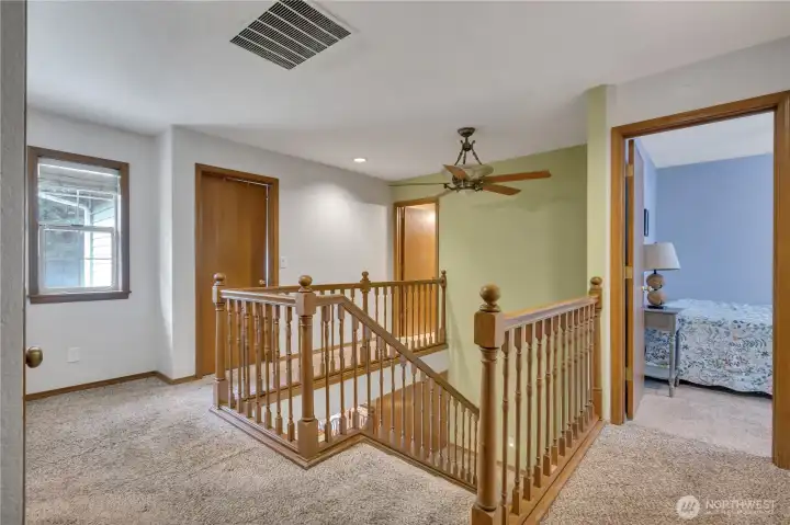 Bright upper-level landing connecting all four bedrooms, offering easy access and open flow.