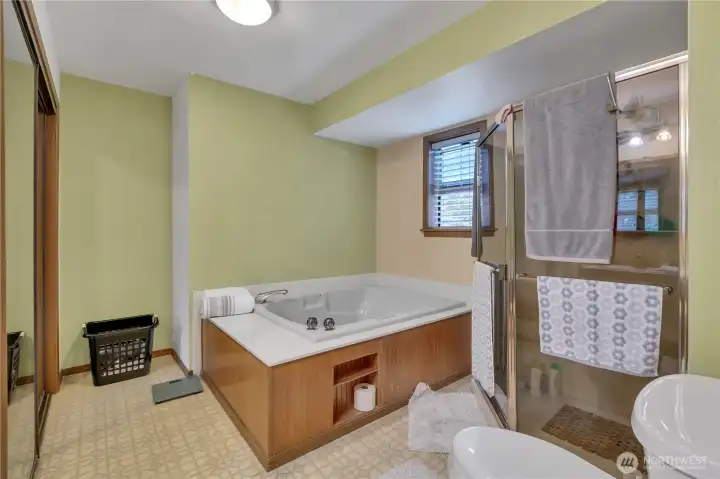 Spacious primary ensuite with a relaxing soaking tub and a separate walk-in shower.