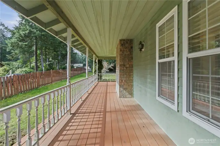 Part of the wrap-around covered deck that flows down to a two-tier deck overlooking the backyard, perfect for entertaining and outdoor living.