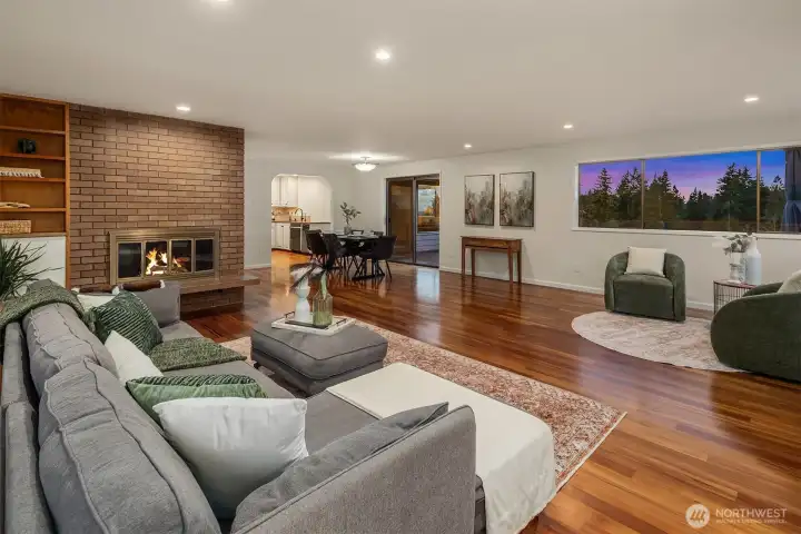 Natural light floods through oversized windows, highlighting the seamless flow between the living area and the scenic outdoors.