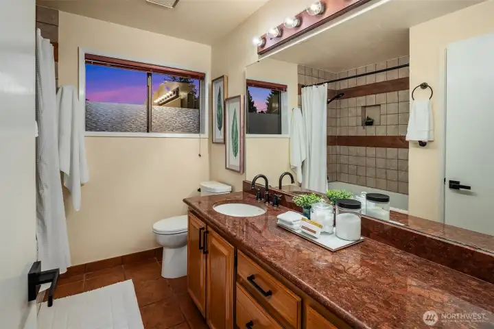 Second bathroom with jetted tub and granite counter.