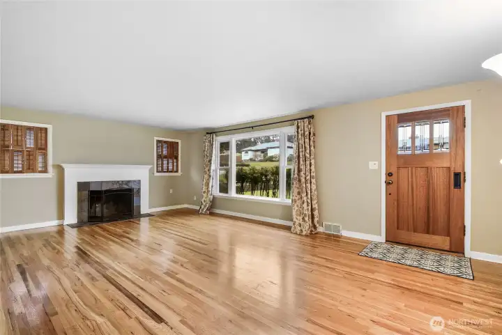 Beautiful Living Room w/hardwood floors, large picture windows & wood-burning slate fireplace