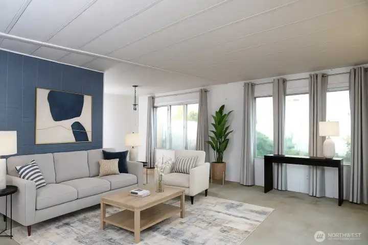 The living room seamlessly flows into the dining area, filled with natural light that creates a warm and inviting atmosphere. VIRTUALLY STAGED