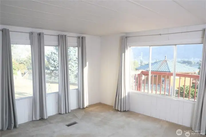 The dining room transitions smoothly into the spacious living area, enhancing the open-concept layout and natural light.