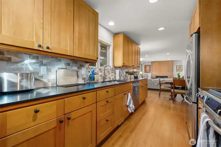 At the stove, the cook is never isolated from the main rooms, dining with living room adjacent.