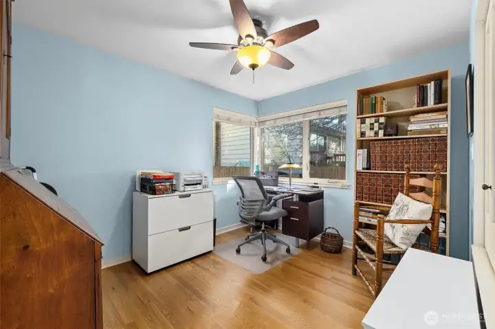 The second bedroom in use as an office. Lovely view to the backyard magnolia tree.