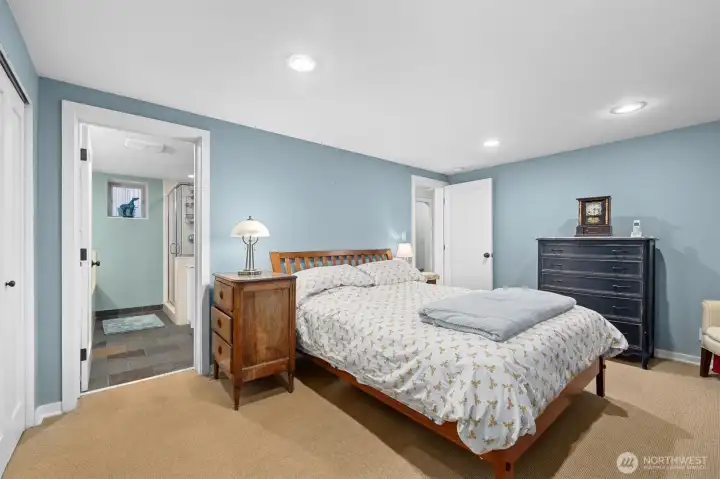 A view of the primary bath entrance from the bedroom. You can see a portion of the double closet on the wall to the left.