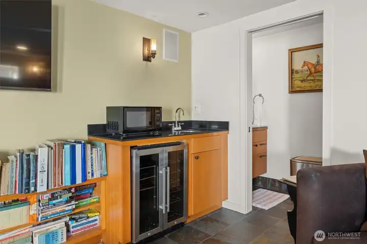 Cold drinks fridge, sink, mini-kitchen convenient to movie nights.