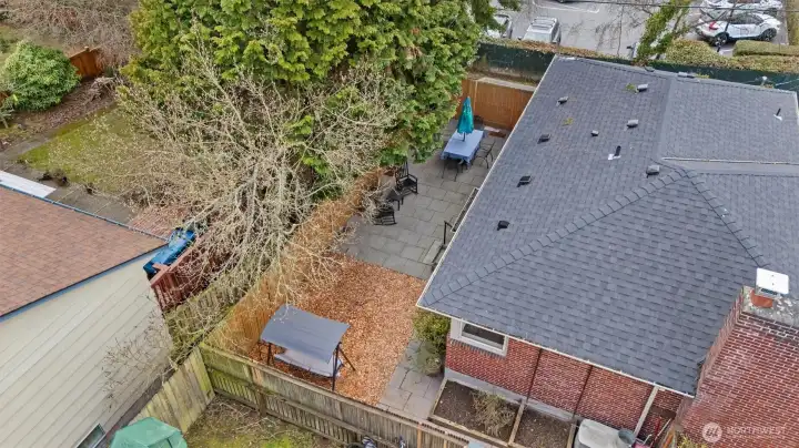 Check out the 2024 new roof! Worry-free home that has it all. Drone photo of partial house perimeter and back yard.