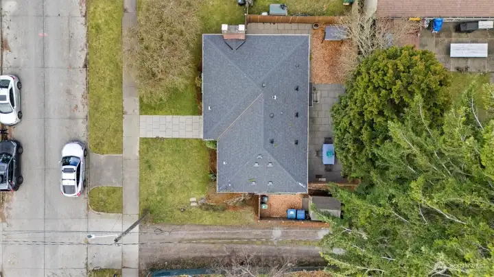 Drone photo with car parked perpendicular to the curb cut.  Plenty of street parking on this residential street.