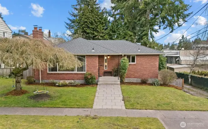 Sweet 1950's brick rambler with fully finished lower level.  Alley access to the right in the photo leads to a separate entrance that could serve an ADU. Market and bus stop within sight.