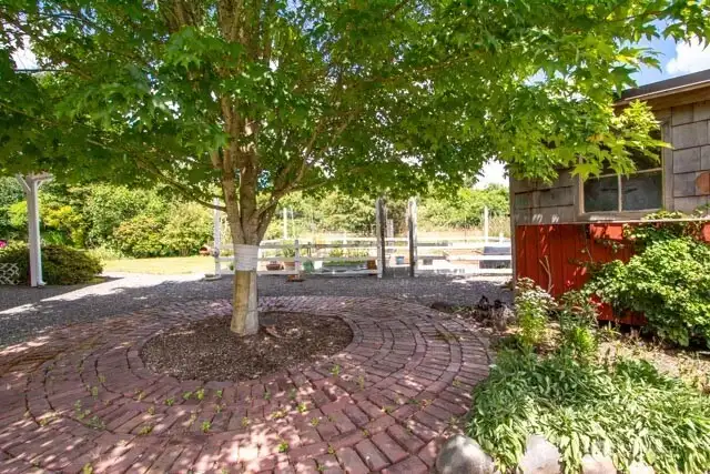 Brick patio welcomes you to the garden area and backyard!