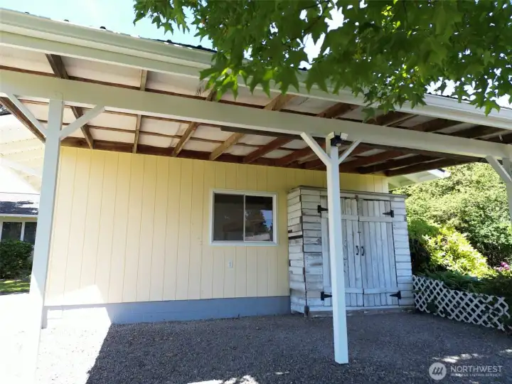 Little wood shed on outside of garage