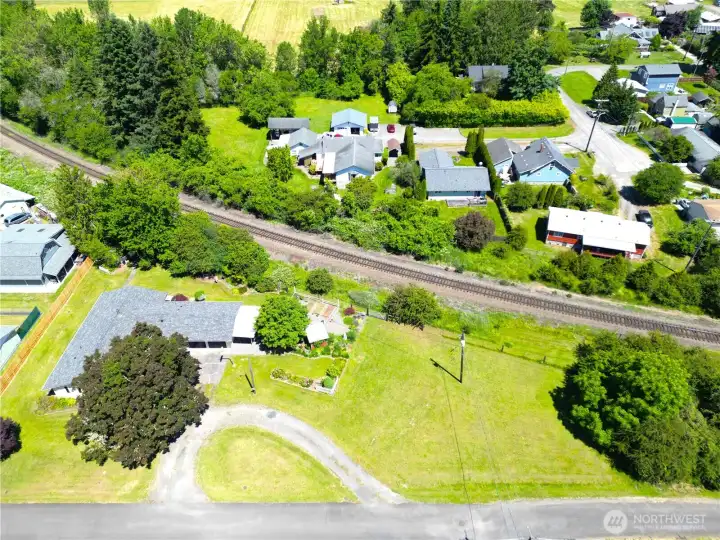 Aerial view of your almost 1/2 acre with a tree line and fence line, enjoy this space on a no-outlet road!