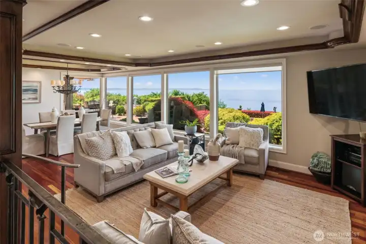 Walls of windows bring the Sound right into the living room, where a cozy stone fireplace and warm wood tones create the perfect spot to take it all in Walls of windows bring the Sound right into the living room, where a cozy stone fireplace and warm wood tones create the perfect spot to take it all in