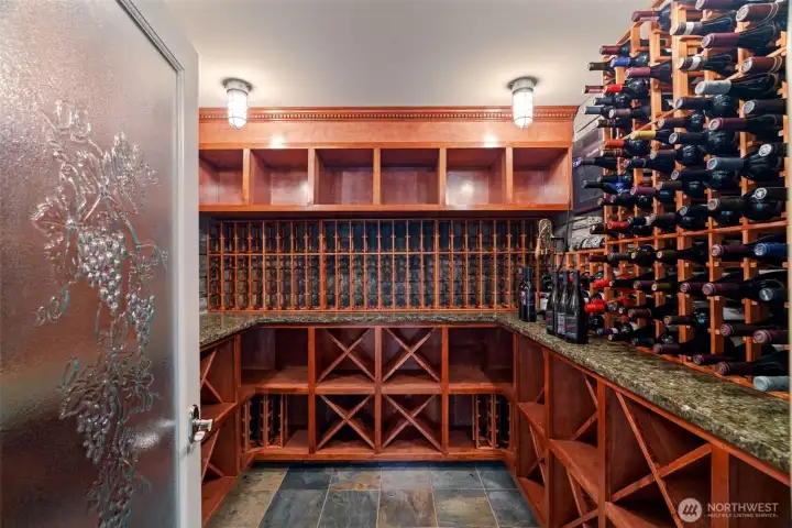 Temperature-controlled wine cellar with custom mahogany racking, granite counters, and slate flooring — built to showcase and store a serious collection. Temperature-controlled wine cellar with custom mahogany racking, granite counters, and slate flooring — built to showcase and store a serious collection.